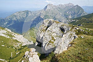 Picteresque view of a huge rock, green hillside, mountain in North Osetia Russia photo